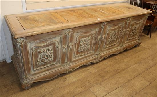 A French provincial chest, the front carved with three foliate panels, W.240cm, D.62cm, H.78cm